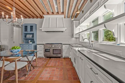 a kitchen with stainless steel appliances granite countertop a stove and cabinets