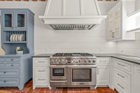 a stove top oven sitting inside of a kitchen