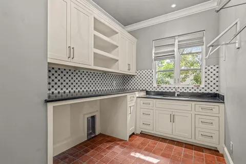 a kitchen with granite countertop cabinets and window