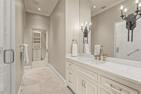 a bathroom with a double vanity sink a mirror and a shower