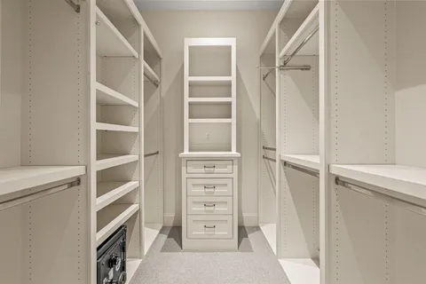 a view of walk in closet with empty racks