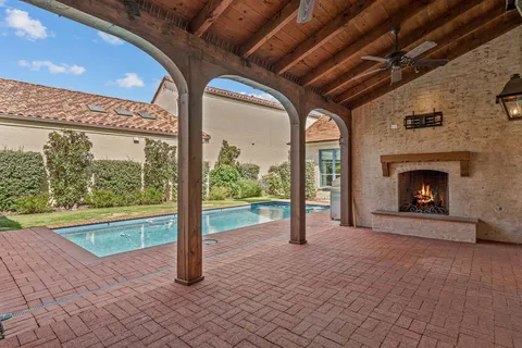a view of an empty room with a fireplace and a window