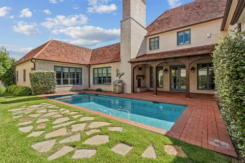 a view of house and yard with swimming pool and wooden fence