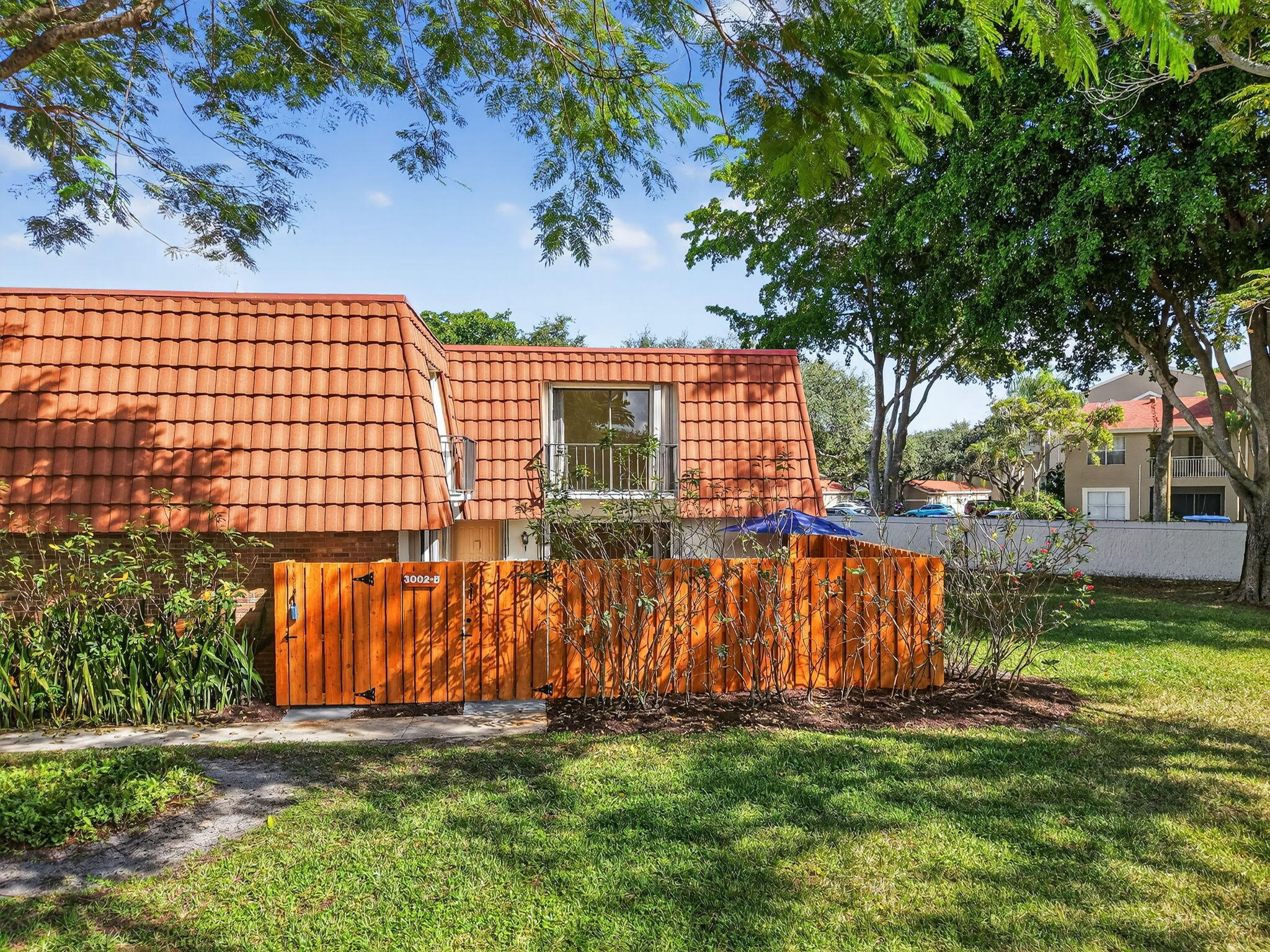 a view of backyard with wooden fence