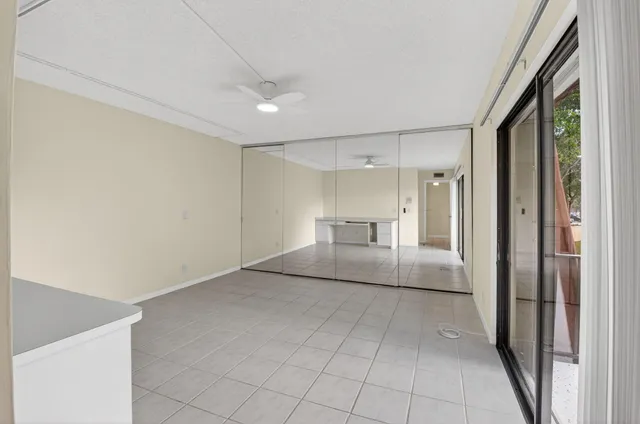 a view of a room with a stylish ceiling fan and entryway