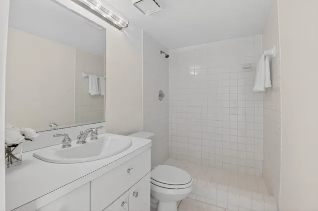 a bathroom with a sink toilet and shower