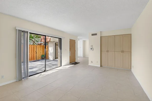 an empty room with sliding glass door