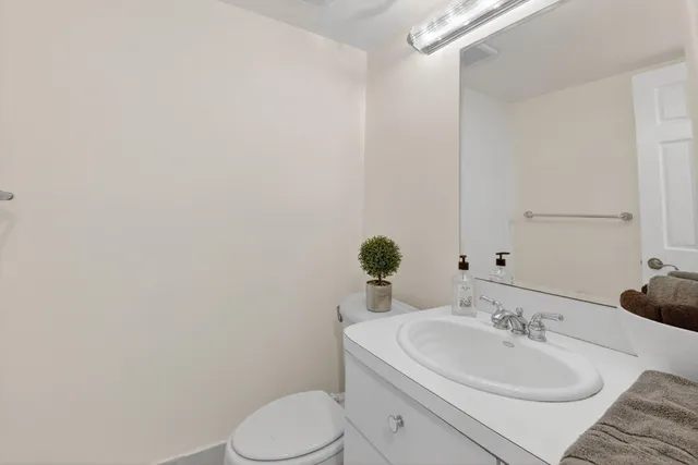 a bathroom with a sink a toilet and mirror