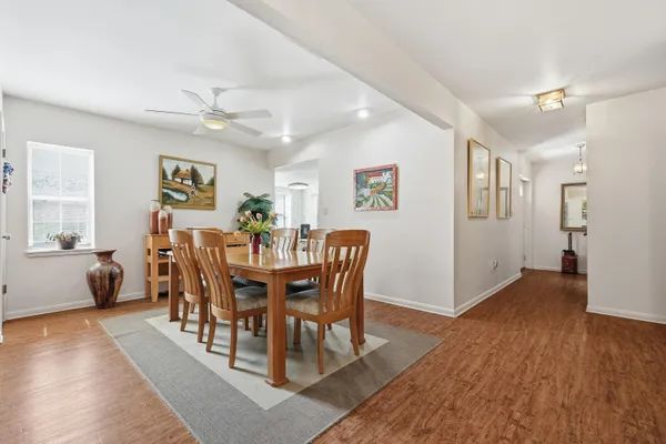 a kitchen with stainless steel appliances granite countertop white cabinets sink and a granite counter top