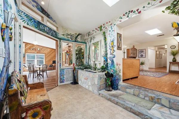 a living room with furniture and kitchen view
