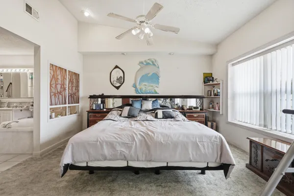 a bedroom with a bed and a cabinet