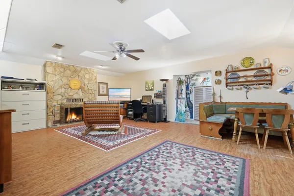 a living room with furniture a rug and a chandelier