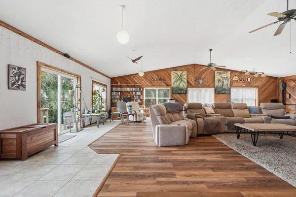 a view of a house with backyard porch and sitting area