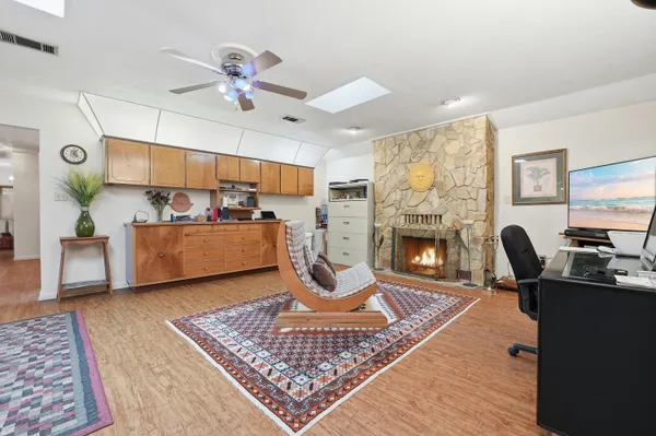 a living room with furniture a flat screen tv and a floor to ceiling window