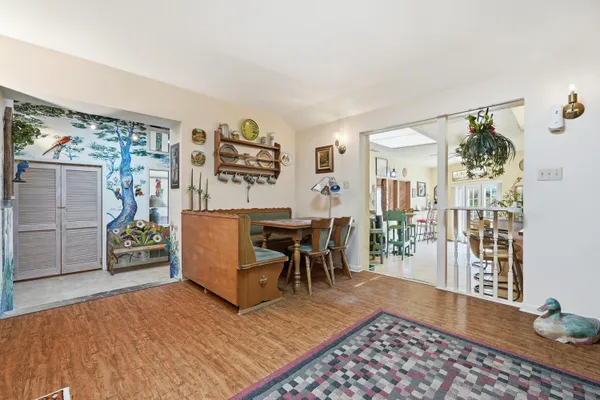 a dining room with furniture and wooden floor
