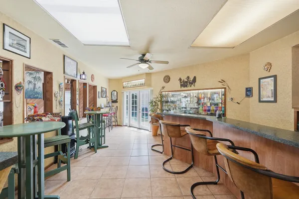 a kitchen with a refrigerator a stove top oven a sink dishwasher and white cabinets next to a window