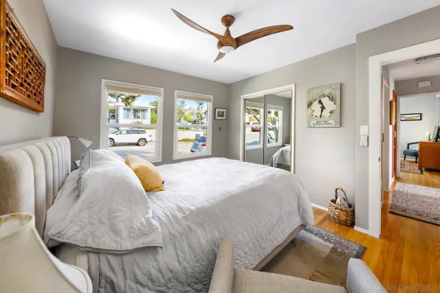 a bed sitting in a bedroom next to a window