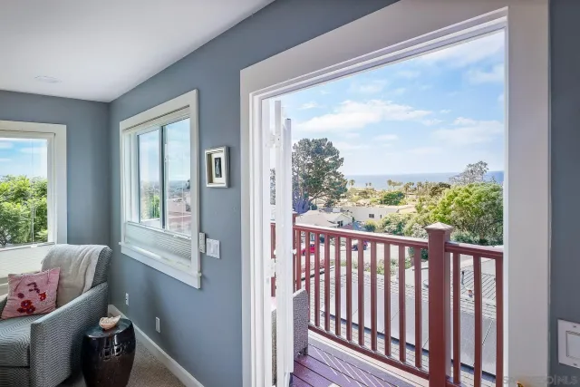 a view of a porch with furniture and floor to ceiling window