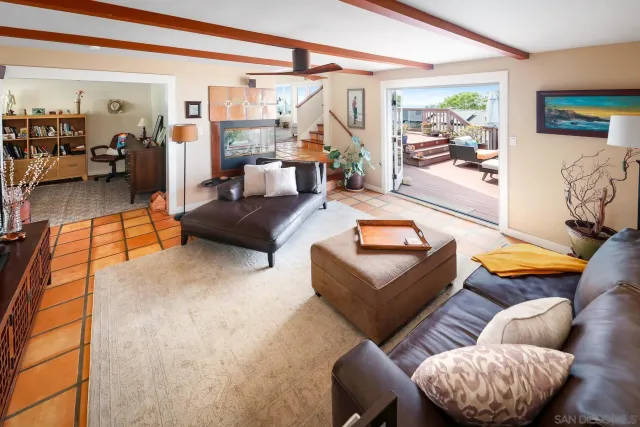 a living room with furniture a rug and a large window