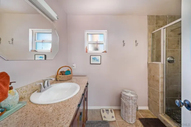 a bathroom with a sink vanity granite and a mirror