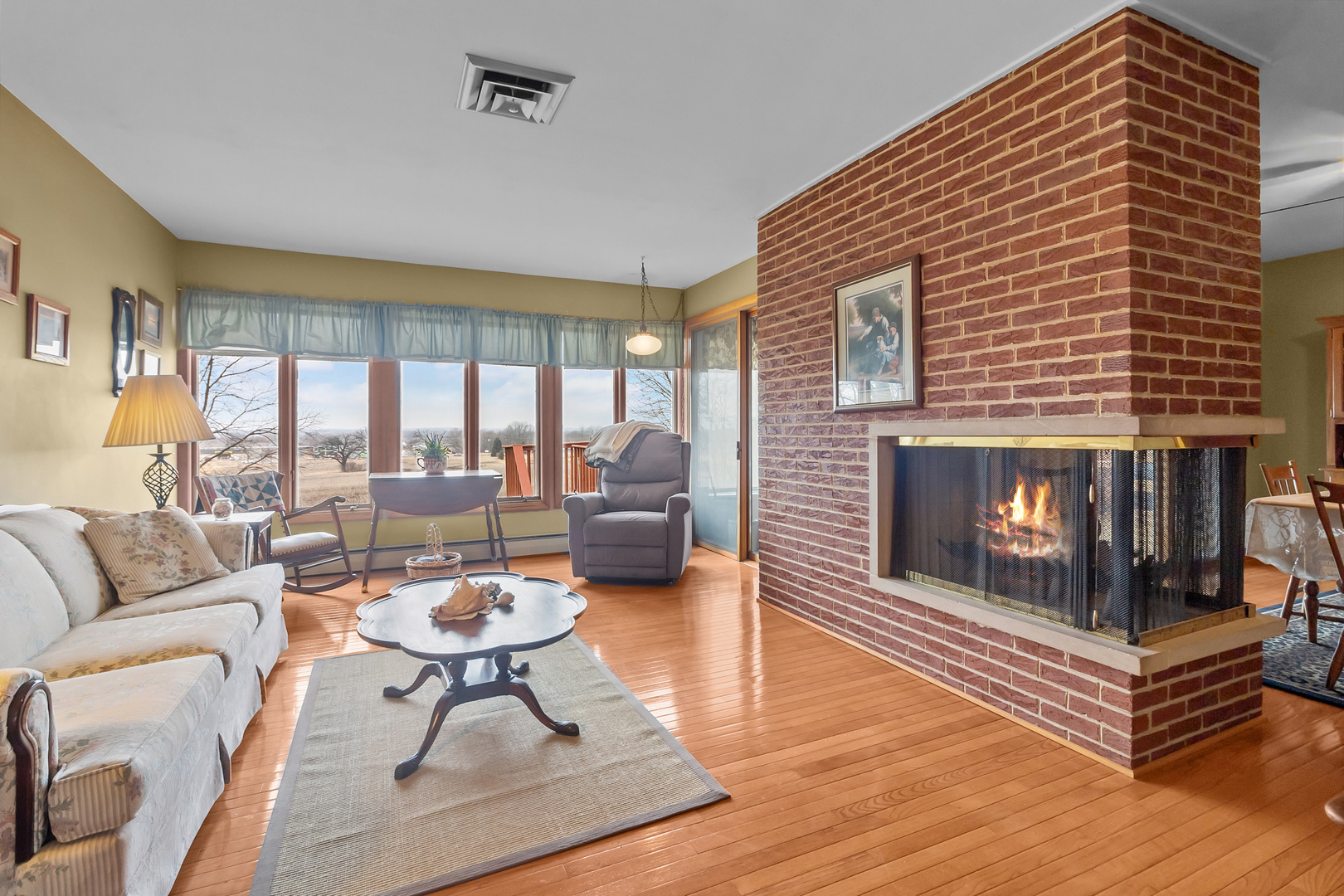 1306 Garfield Road Harvard, IL 60033 - Photo 5 of 38 a living room with furniture a fireplace and a table