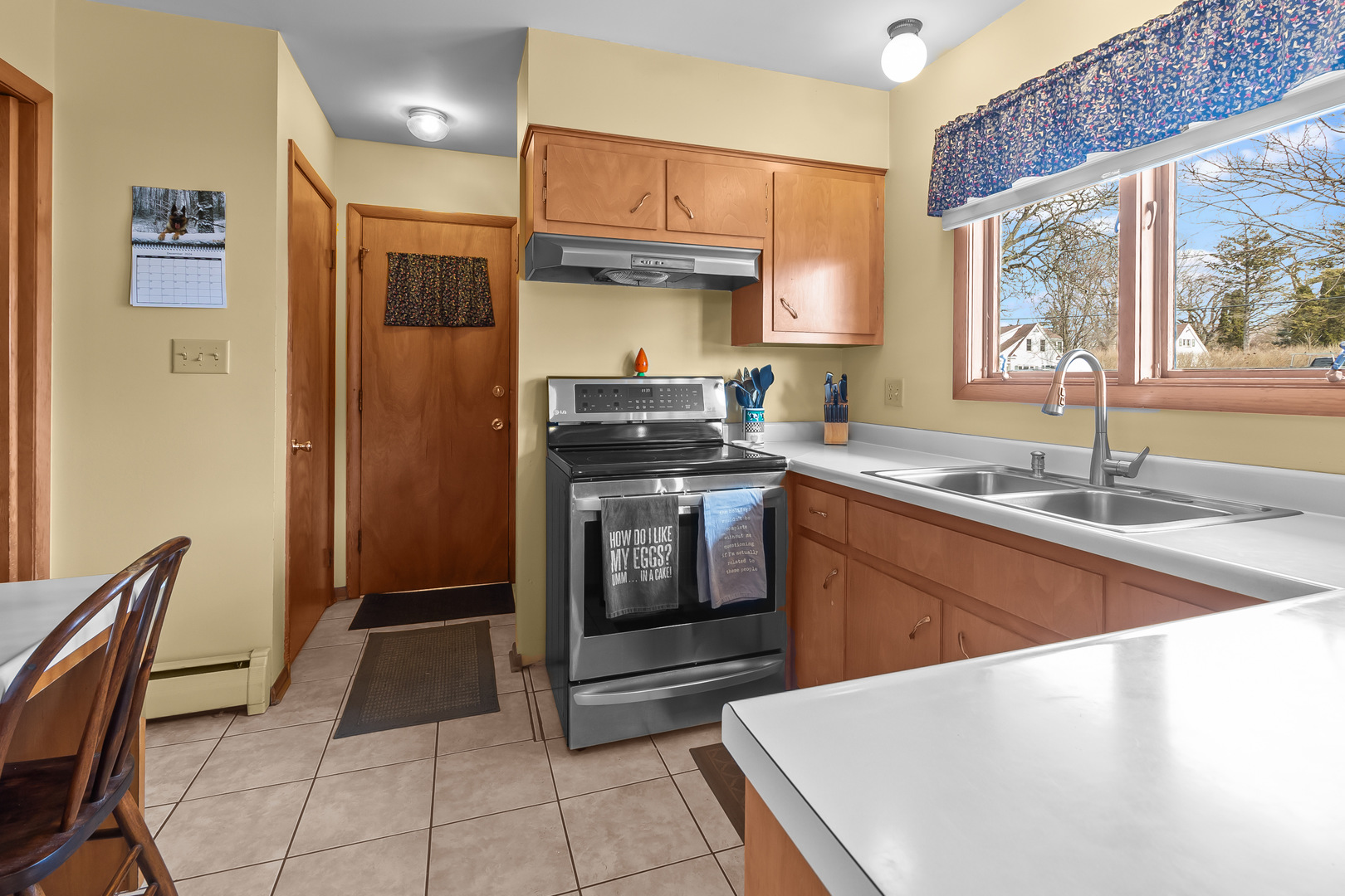 1306 Garfield Road Harvard, IL 60033 - Photo 10 of 38 a kitchen with granite countertop a sink stove and refrigerator