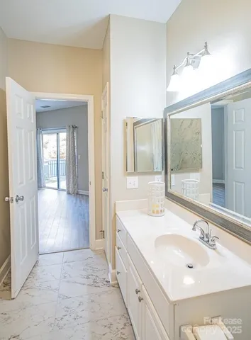 a bathroom with a sink double vanity granite and a mirror