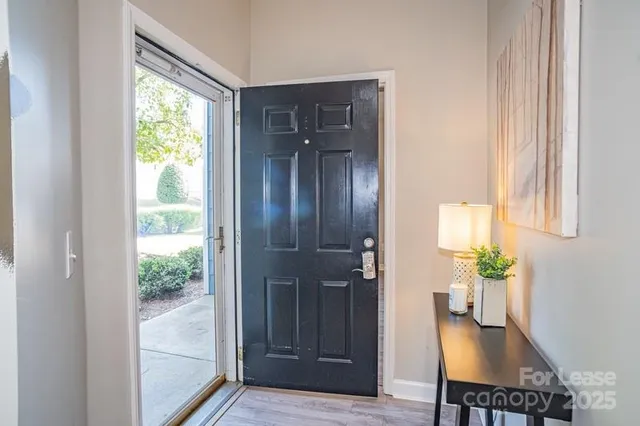 a view of a hallway that has an dining area wooden floor and a window