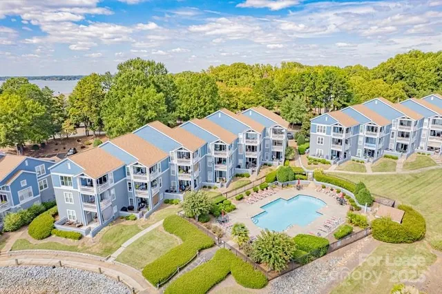 a aerial view of a house with a big yard and large trees