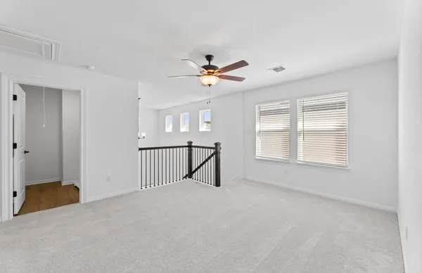 a view of staircase with wooden floor and white walls