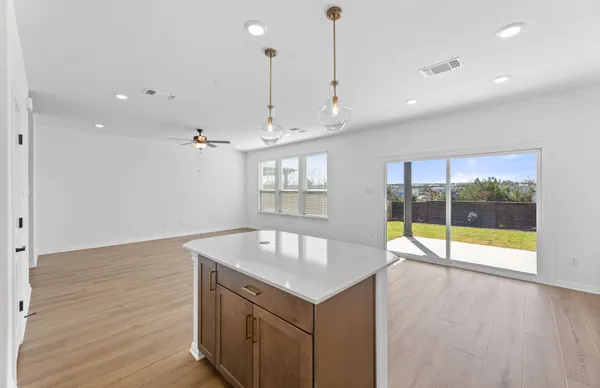 a kitchen with stainless steel appliances granite countertop a sink stove a refrigerator and a oven with wooden floor