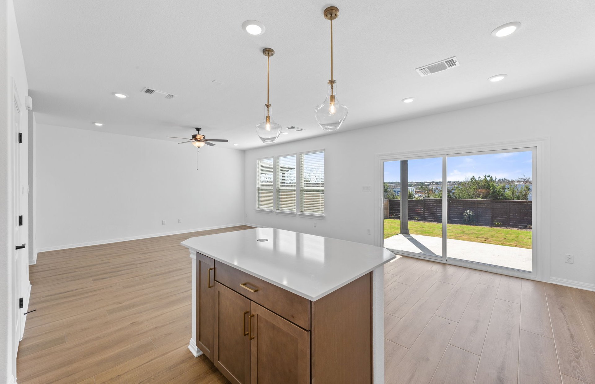 528 Knot Drive Leander, TX 78641 - Photo 6 of 29 a view of an empty room with kitchen view and a floor to ceiling window