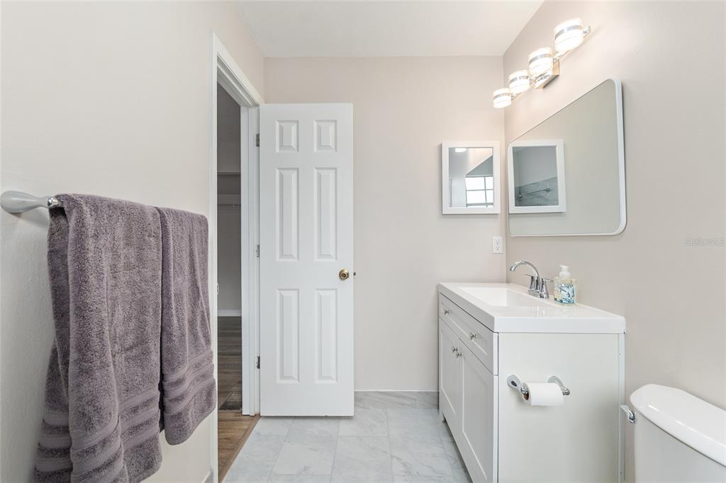 9755 Southwest 52nd Road Gainesville, FL 32608 - Photo 29 of 43 a bathroom with a sink a mirror and a toilet