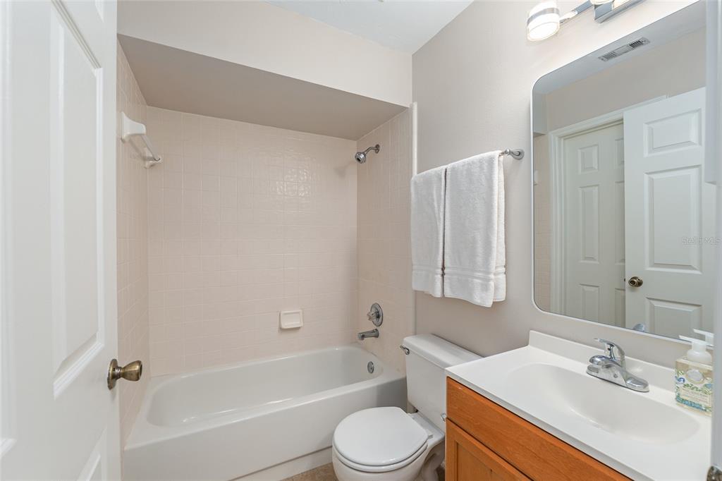 9755 Southwest 52nd Road Gainesville, FL 32608 - Photo 37 of 43 a bathroom with a bathtub shower sink vanity mirror and toilet