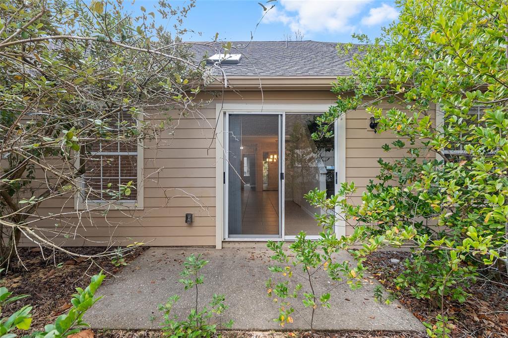 9755 Southwest 52nd Road Gainesville, FL 32608 - Photo 39 of 43 a view of a brick house with a large windows and flower plants