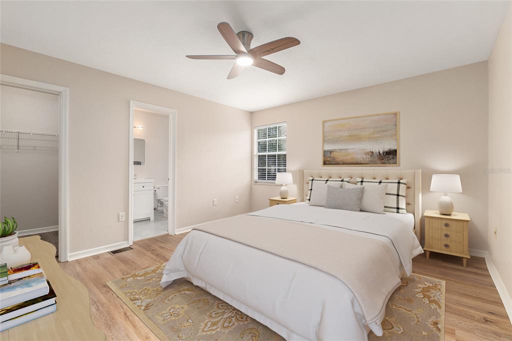9755 Southwest 52nd Road Gainesville, FL 32608 - Photo 4 of 43 a bedroom with a large bed and a chandelier