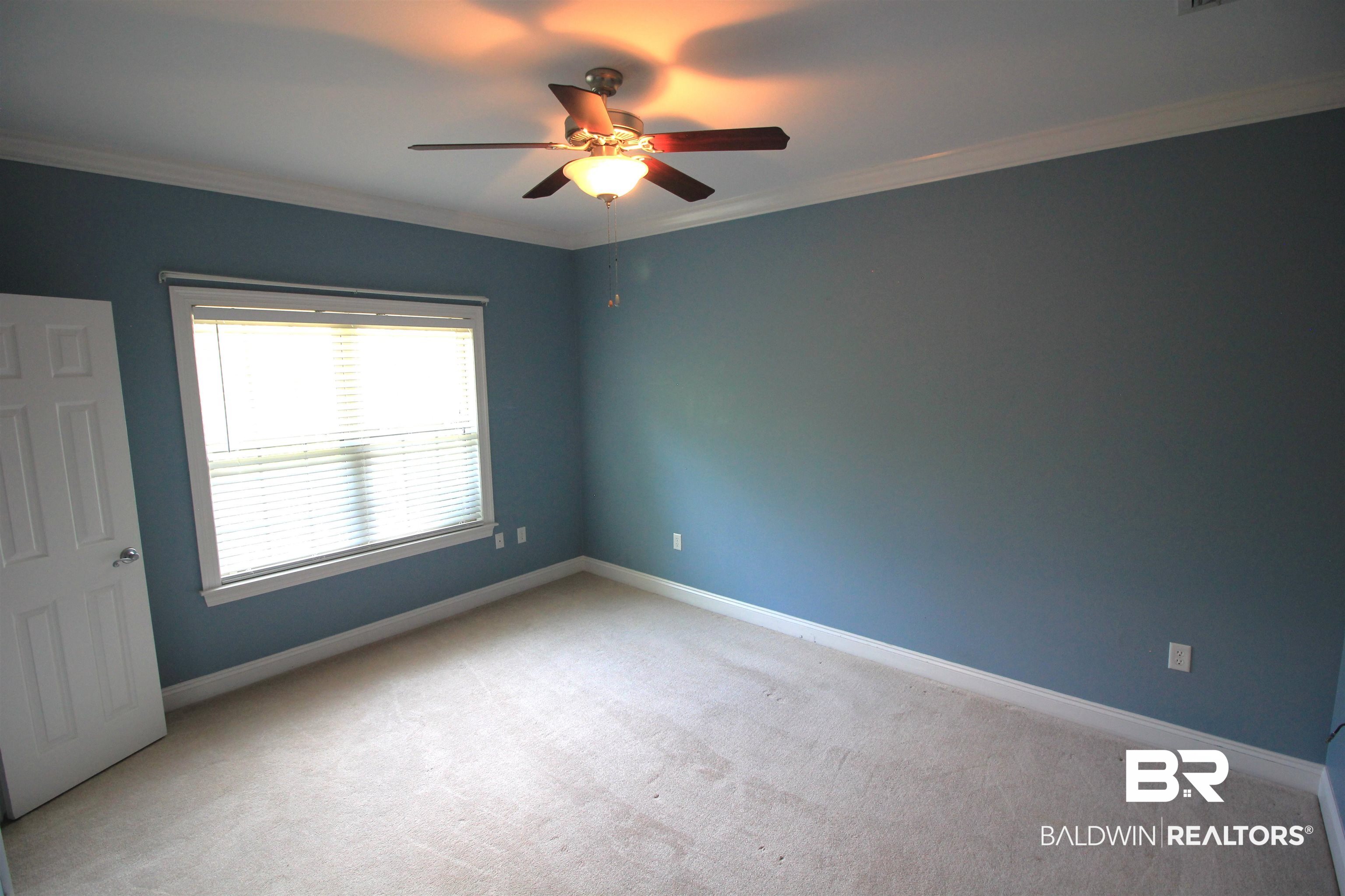 306 South Tee Drive Fairhope, AL 36532 - Photo 21 of 37 Unfurnished room with carpet flooring, ceiling fan, and ornamental molding