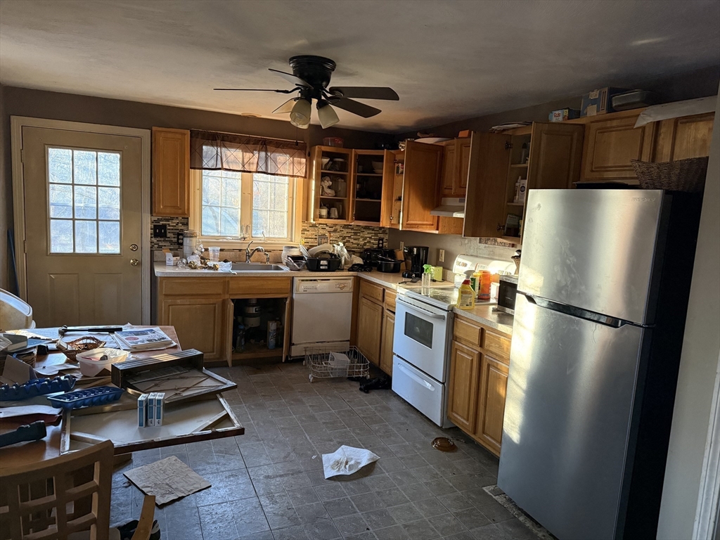 6 Rumford Road Norton, MA 02766 - Photo 4 of 10 a kitchen with a refrigerator a stove a sink and a dining table