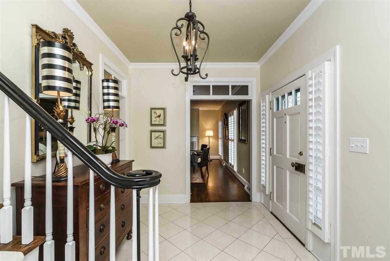 7116 North Ridge Drive Raleigh, NC 27615 - Photo 3 of 25 a view of a hallway with windows and stairs
