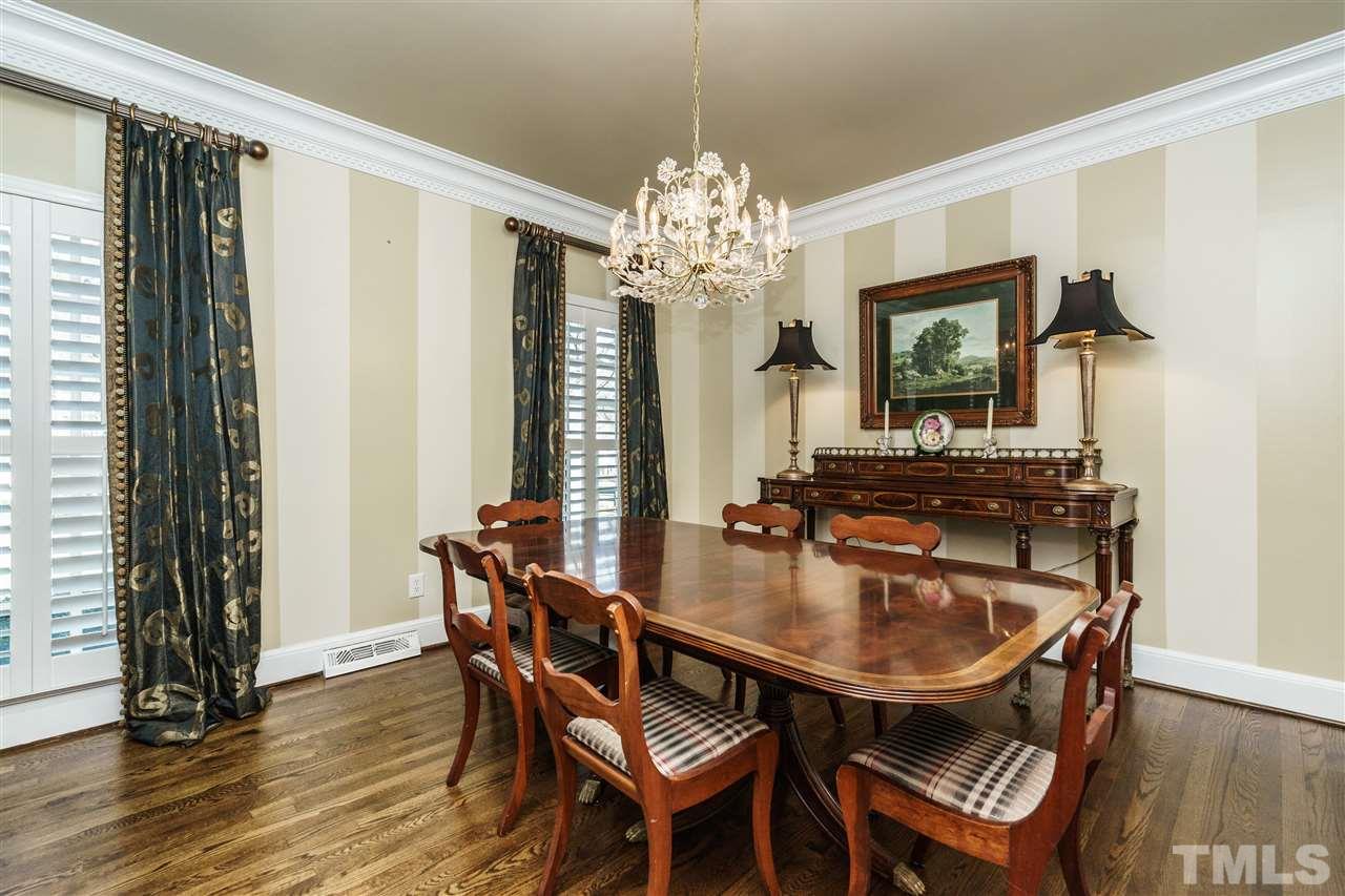 7116 North Ridge Drive Raleigh, NC 27615 - Photo 5 of 25 a dining room with furniture a chandelier and wooden floor