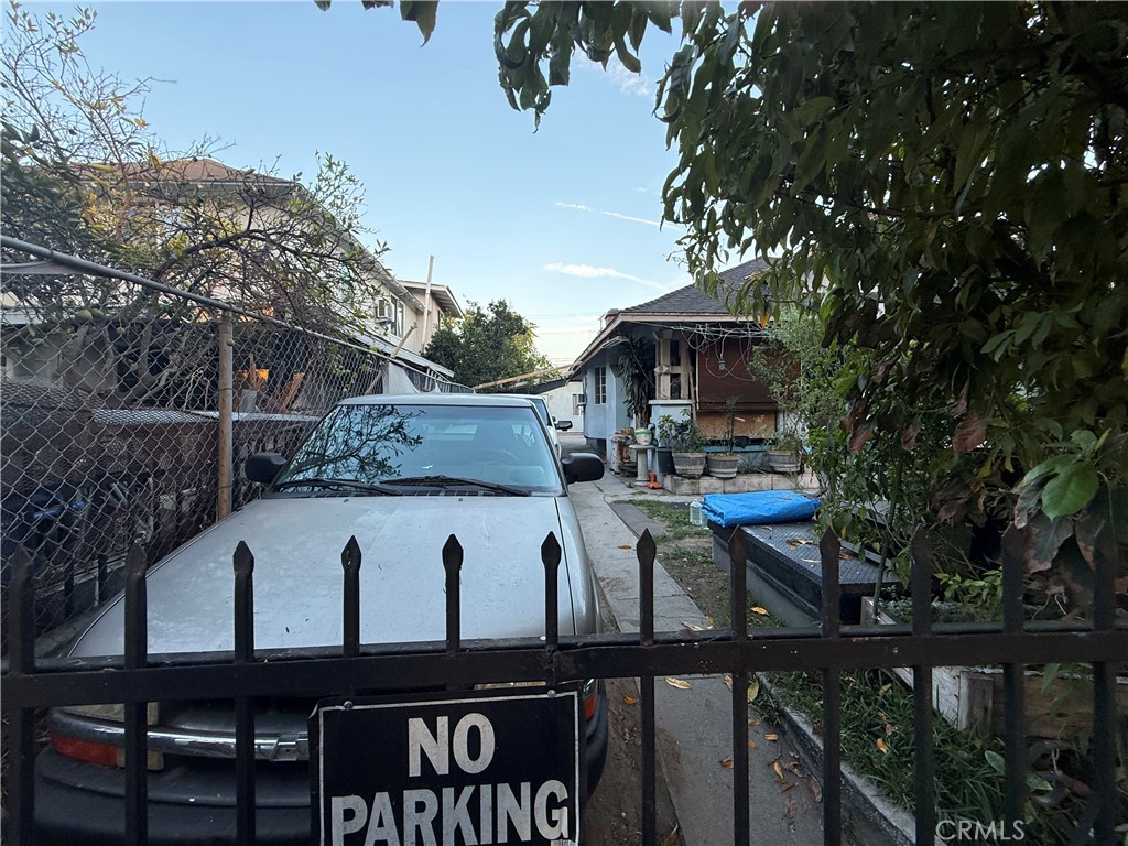 4020 Trinity Street Los Angeles, CA 90011 - Photo 20 of 22 a view of a patio with table and chairs with wooden fence and plants