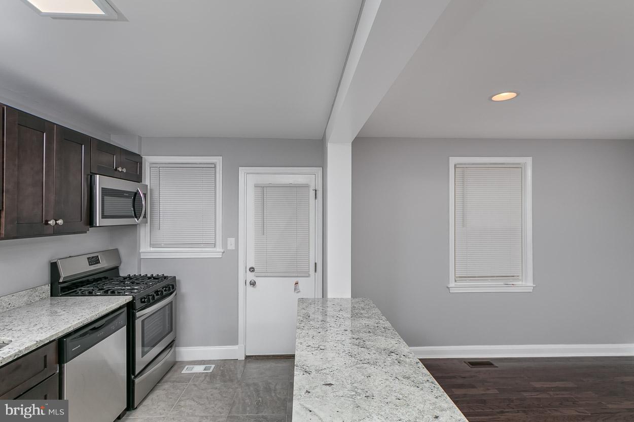 1901 Crestview Road Baltimore, MD 21239 - Photo 11 of 30 a kitchen with stainless steel appliances granite countertop a stove a sink and a refrigerator