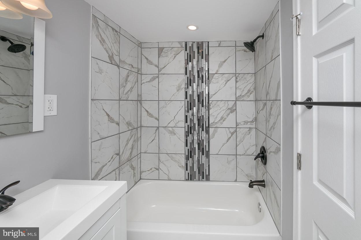 1901 Crestview Road Baltimore, MD 21239 - Photo 27 of 30 a bathroom with a bathtub and a shower