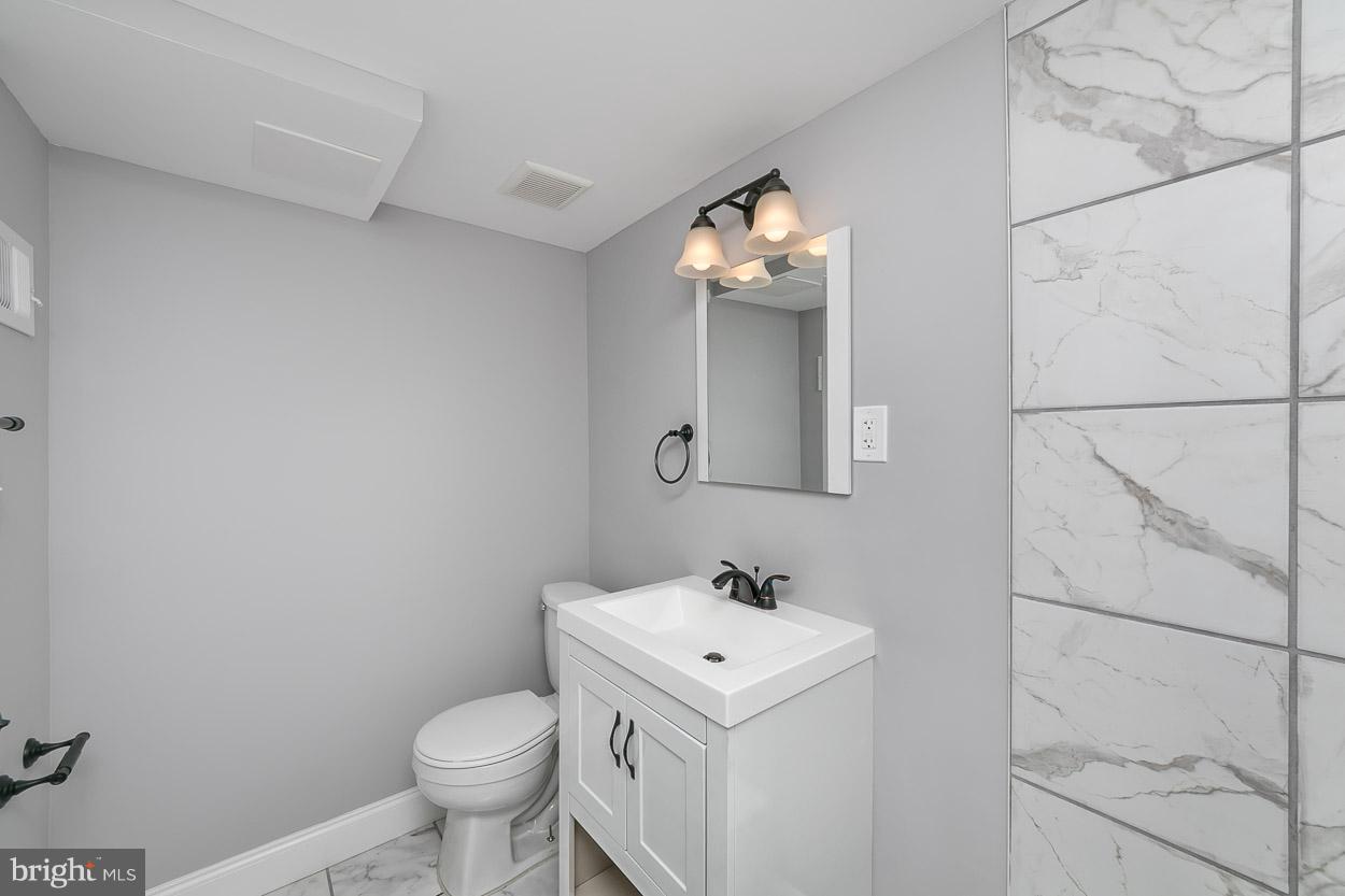 1901 Crestview Road Baltimore, MD 21239 - Photo 28 of 30 a bathroom with a sink toilet and vanity