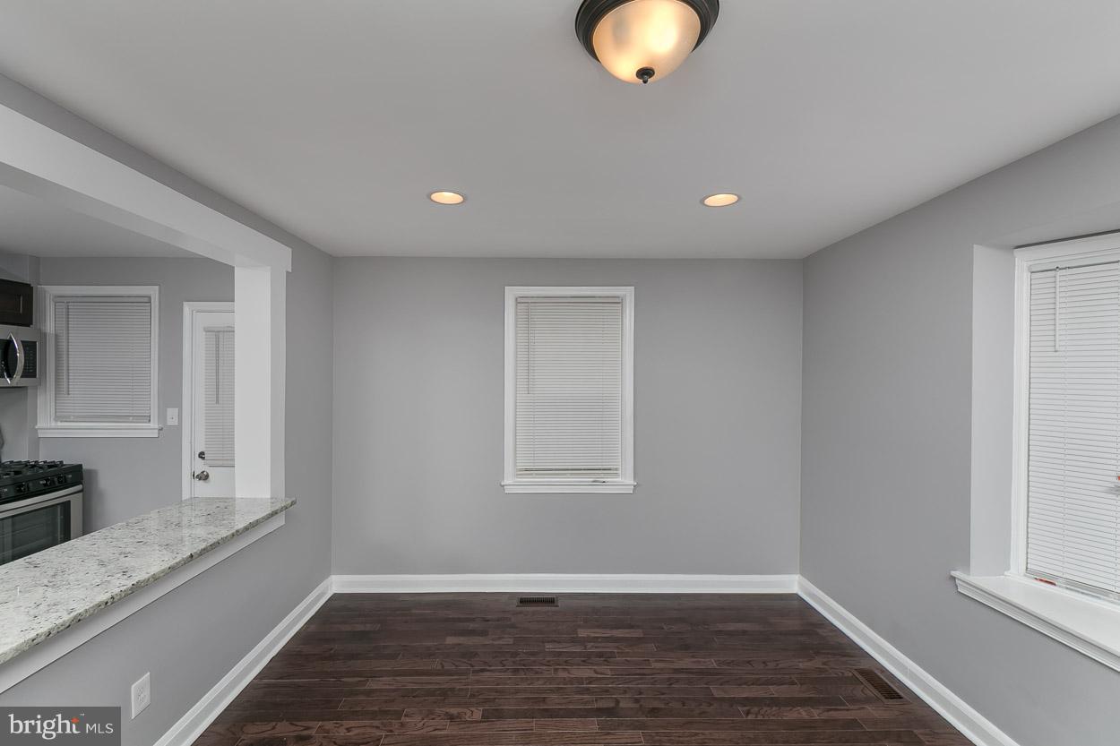 1901 Crestview Road Baltimore, MD 21239 - Photo 6 of 30 a view of an empty room with wooden floor and a window
