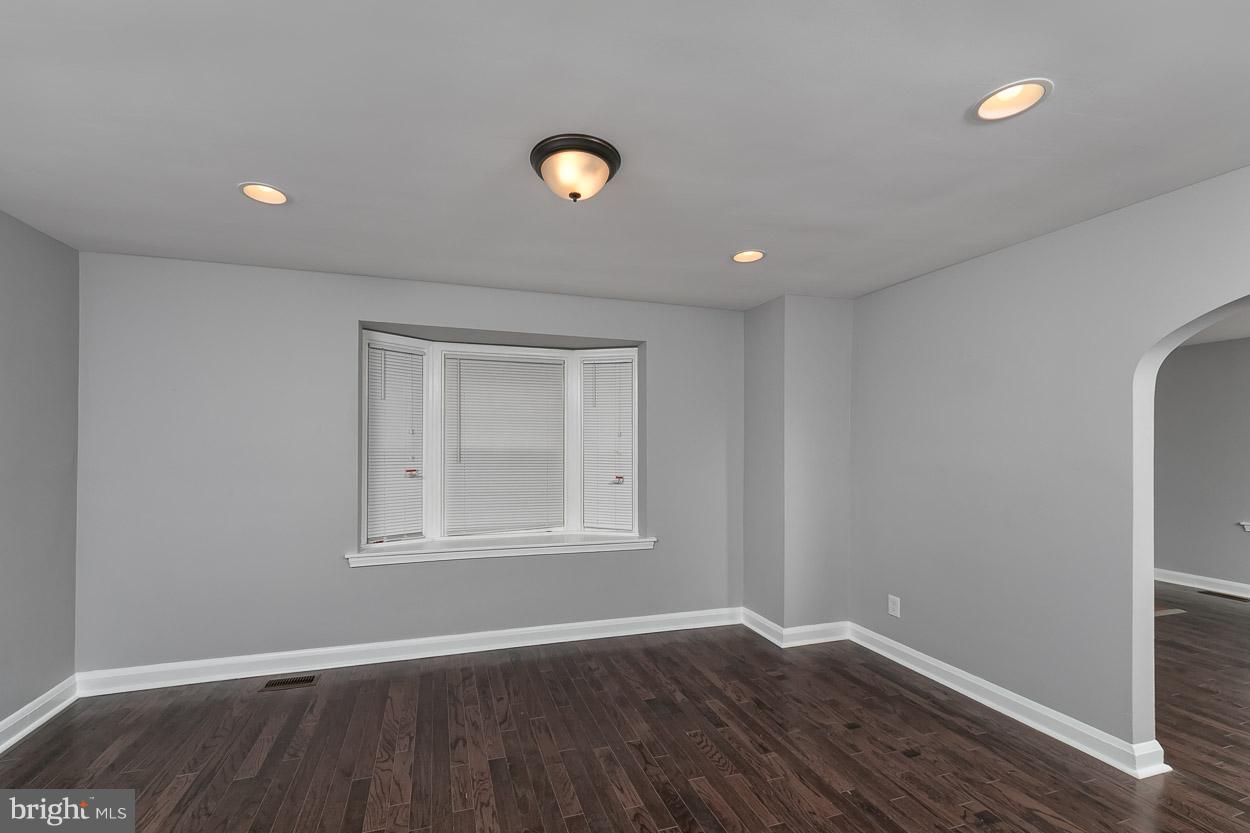 1901 Crestview Road Baltimore, MD 21239 - Photo 7 of 30 an empty room with wooden floor and windows
