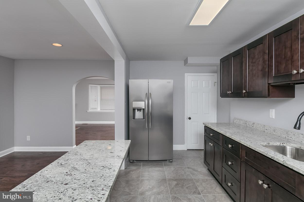 1901 Crestview Road Baltimore, MD 21239 - Photo 9 of 30 a kitchen with stainless steel appliances granite countertop a refrigerator a stove and a sink