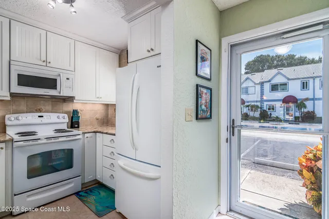 a kitchen with stainless steel appliances granite countertop a refrigerator and a stove