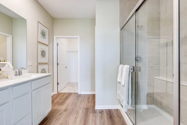 a bathroom with a double vanity sink a mirror and a shower