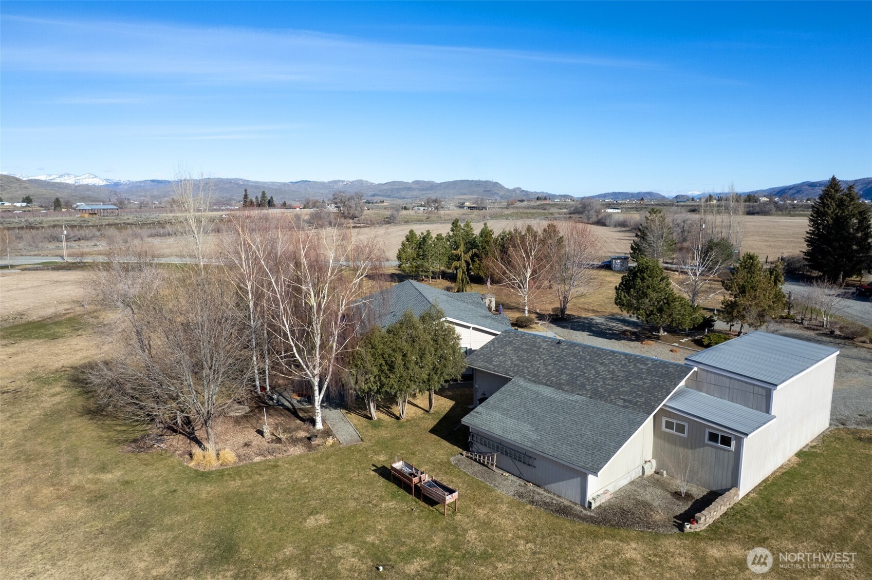 95 Woods Road Omak, WA 98841 - Photo 3 of 40 an aerial view of a house with a yard and lake view
